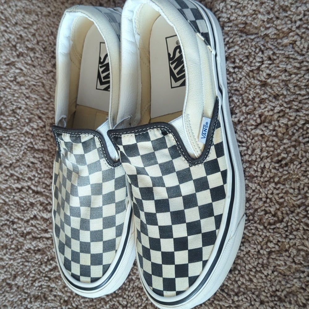 Black and white checkered Vans slip-ons